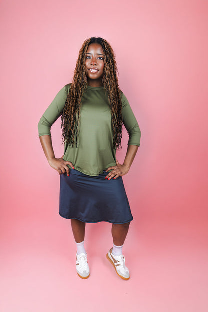 Transcendent Active Performance Quarter Sleeve Top in rich army green, featuring a modest, athletic fit with quarter-length sleeves, smooth performance fabric, and a flattering silhouette designed for movement and everyday wear.