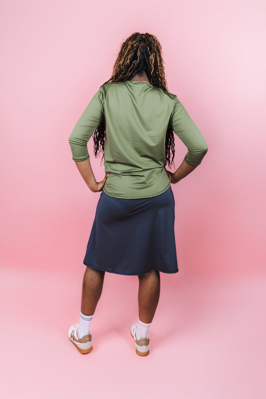 Transcendent Active Performance Quarter Sleeve Top in rich army green, featuring a modest, athletic fit with quarter-length sleeves, smooth performance fabric, and a flattering silhouette designed for movement and everyday wear.