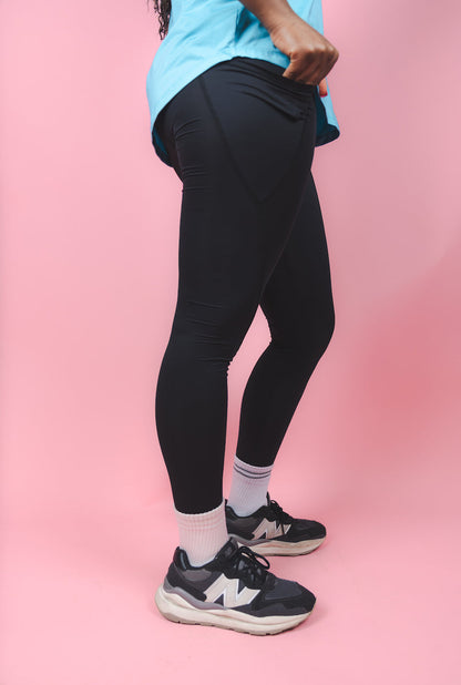 Transcendent Active black 7/8 leggings with side pockets, featuring a sleek, high-rise fit, smooth performance fabric, and a flattering length designed for movement and everyday wear.