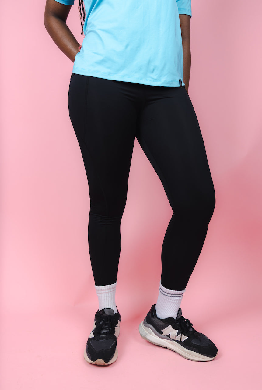 Transcendent Active black 7/8 leggings with side pockets, featuring a sleek, high-rise fit, smooth performance fabric, and a flattering length designed for movement and everyday wear.