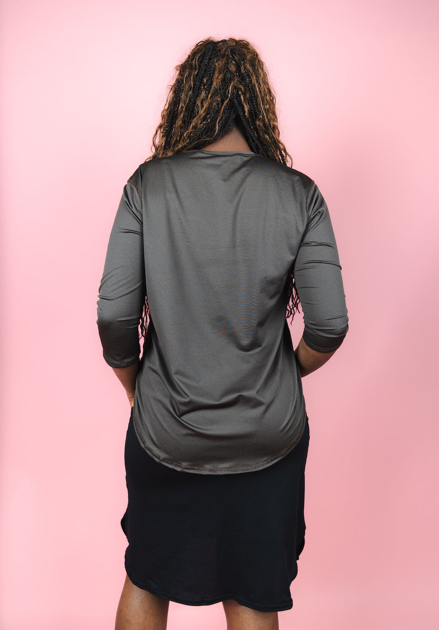 Transcendent Active Performance Quarter Sleeve Top in rich chocolate brown, featuring a modest, athletic fit with quarter-length sleeves, smooth performance fabric, and a flattering silhouette designed for movement and everyday wear.