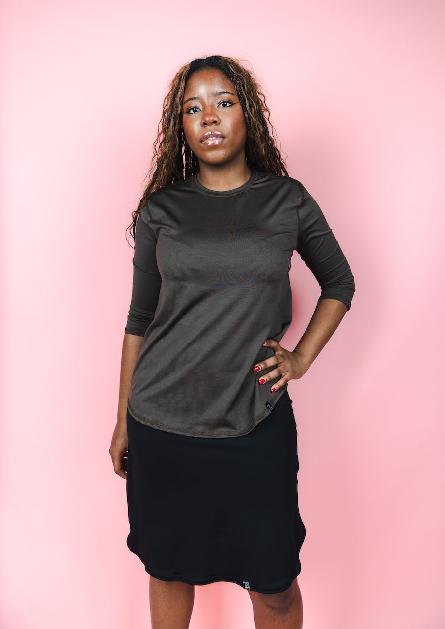 Transcendent Active Performance Quarter Sleeve Top in rich chocolate brown, featuring a modest, athletic fit with quarter-length sleeves, smooth performance fabric, and a flattering silhouette designed for movement and everyday wear.