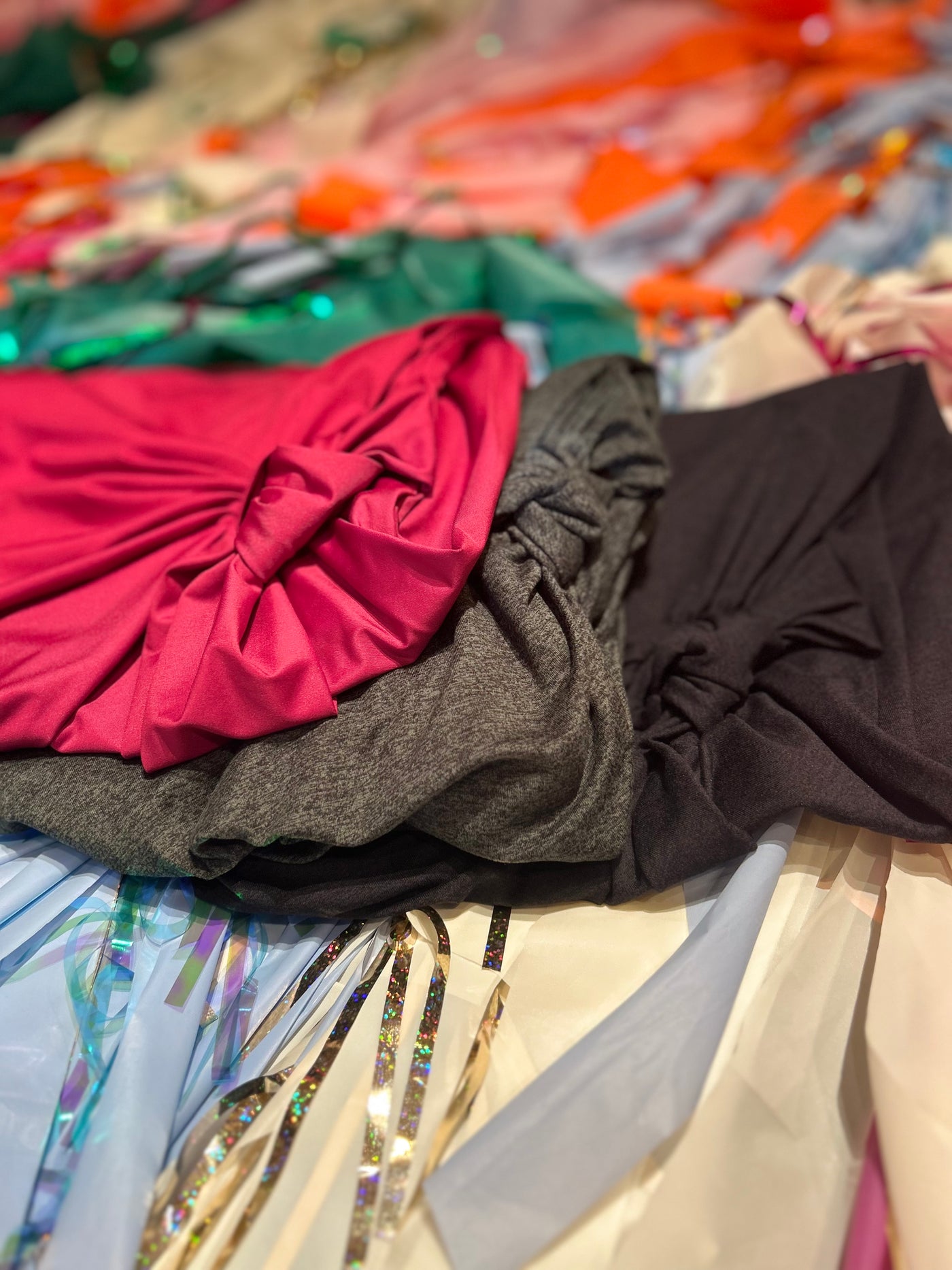 Three Transcendent Active knot tops in pink, gray, and brown stacked together — small-batch, made in LA